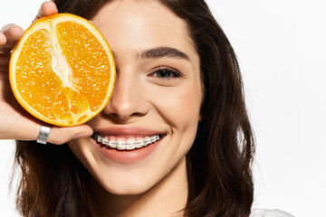 Bright summer smiles and citrus vibes with a fashionable young woman holding an orange