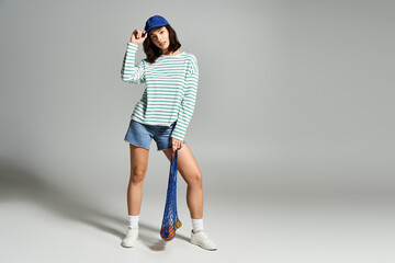 Fashionable summer style showcased by a young woman engaging in a playful pose indoors