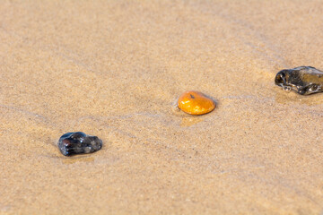 Galets sur du sable en bord de mer
