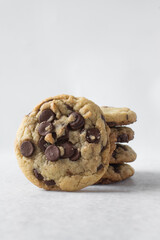 Large chocolate chip cookies on a white countertop, homemade chocolate chip cookies on a white background