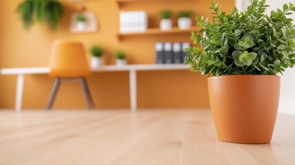 A vibrant green plant sits in a terracotta pot on a wooden floor, surrounded by a stylish workspace featuring an orange wall