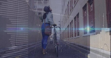 Woman with bicycle looking up in alley with digital data overlay animation - Powered by Adobe