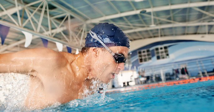 Swimming, energy and athlete in pool, water and practice for competition, healthy and workout in morning. Active, swimmer and person with routine for performance, exercise and training for sports