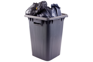 Overflowing black trash bin filled with garbage bags in a tidy kitchen environment