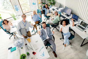 Professional team celebrating success in a modern office setting