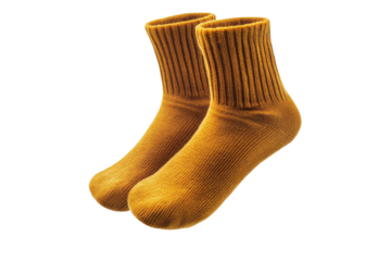 Cozy mustard yellow socks sitting on a soft surface in a warm, inviting indoor space during autumn