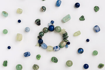 Assorted gemstone bracelets and raw crystals for crafting. Handmade stone bead bracelets with...