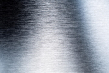 Metallic surface with a brushed finish reflecting light and textures under natural illumination in a spacious setting