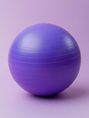 Obraz premium Isolated purple exercise ball on a matching background showcasing fitness equipment in a studio setting with a clean and minimalist style