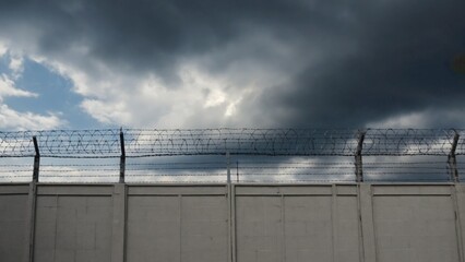 Fototapeta premium A fence with barbed wire on top