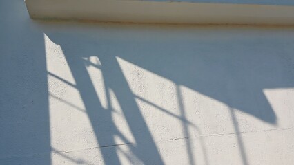 A dark shadow of a street sign on a brick wall, useful for urban or cityscape themed images