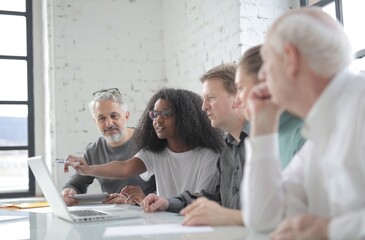 people in the office working in front of a computer