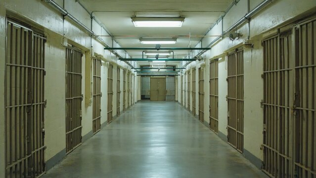 Long corridor with jail cells and guards