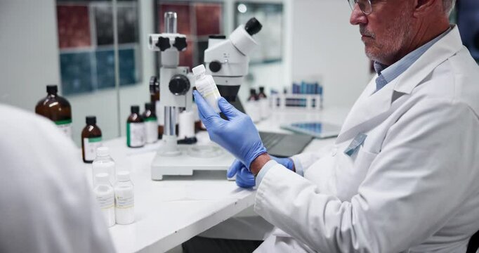 Label, pharmacist and man with medicine, lab and info for treatment of disease, healthcare and science. Pharmaceutical, medical professional and mature person with container, serious and antibiotics