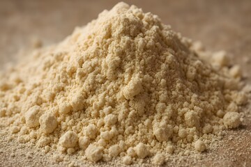 Pile of finely ground yellow flour on a blurred background.
