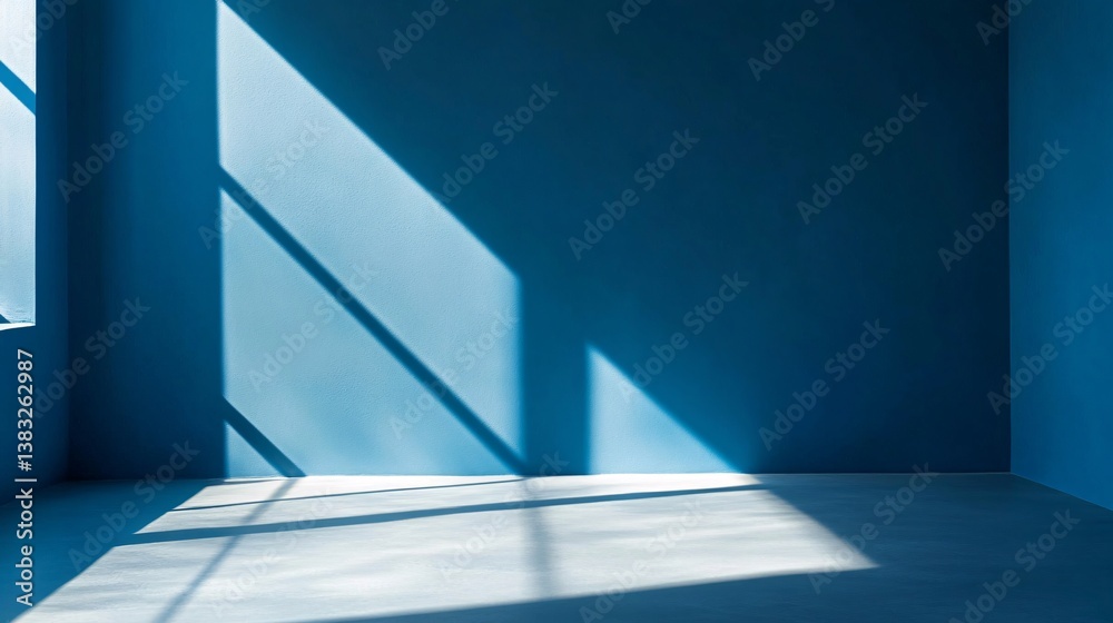 Aufkleber sunlight casting geometric shadows in empty room with blue walls