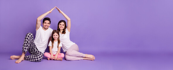 Portrait of three person cheerful full family dad mom offspring daughter wearing pajama sitting...