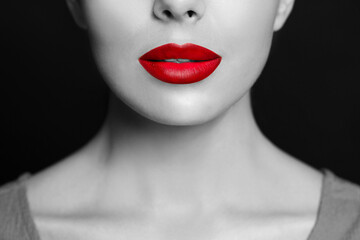 Young woman with beautiful red lips, closeup. Black and white effect with color accent