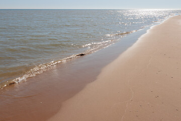 The morning sunshine reflects bightly off the calm surface of Lake Michigan  at Harrington Beach State Park, Belgium, Wisconsin
