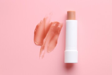 Moisturizing lip balm and lipstick on pink background, top view