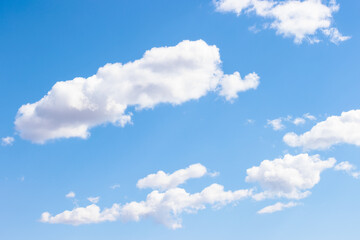 Puffy white clouds drift high in the blue sky in late March over Devil's Lake State Park, Baraboo, Wisconsin