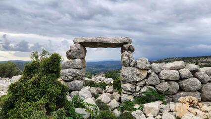 A stone gateway, commonly found in many ancient settlements of Ancient Cilicia, is located within the ruins of Sakizlik, in the Sağlıklı neighborhood of Tarsus, Mersin.