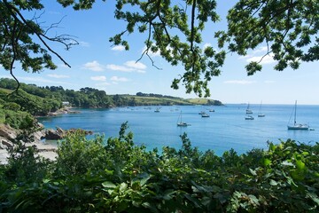 Sailing yachts in the Helford River at the Cornwall Coast in England as seen from Trebah Botanical Gardens