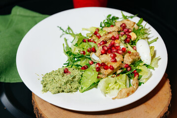 Chicken salad with pomegranate and walnut sauce.