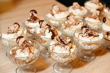 Tiramisu cups with whipped cream and chocolate.
