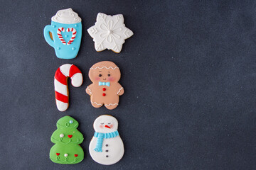Gingerbread man snowman cane decorated with white sugar glaze. Food background copy space. Christmas tree cookies collection.