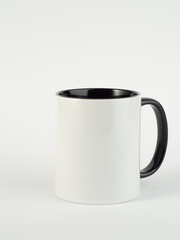Two-tone 11oz mug on isolated background. Mug with black handle and inner part.