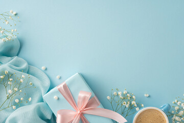Stylish composition featuring a gift box with a light pink ribbon, delicate flowers, and a coffee...