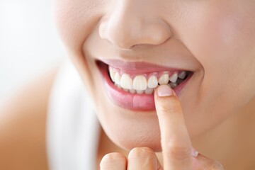 Fototapeta premium Woman touches her teeth, dental care concept.