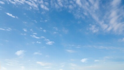 Obraz premium Light Blue Vault of Heaven, Filmy Clouds Wandering. The light blue sky is pure and vast. A few filmy clouds float leisurely, as if dancing gently, adding a touch of leisure and agility to the boundles