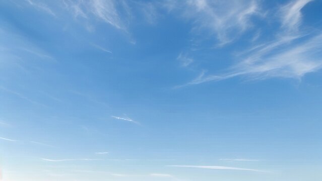 Light Blue Vault of Heaven, Filmy Clouds Wandering. The light blue sky is pure and vast. A few filmy clouds float leisurely, as if dancing gently, adding a touch of leisure and agility to the boundles