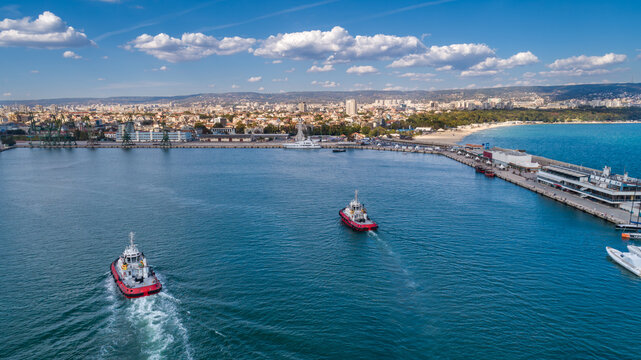 Aerial view of the city of Varna and the harbor with two tugboats passing by. Varna is the sea capital of Bulgaria.