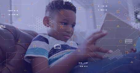 Young boy using tablet with digital data processing animation overlay - Powered by Adobe
