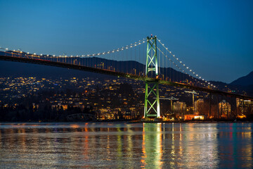 Lions Gate Bridge at night. View from Stanley Park Seawall. Vancouver, British Columbia, Canada.