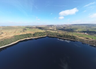 Aerial view of reservoir surrounded by trees and countryside. Taken in Entwistle Bolton Lancashire. 
