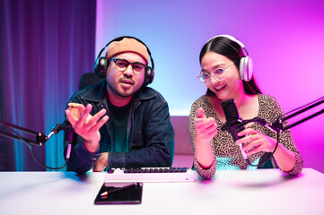 Teenagers, men and women, host podcasts in a room using LED lights, computers, headphones,...