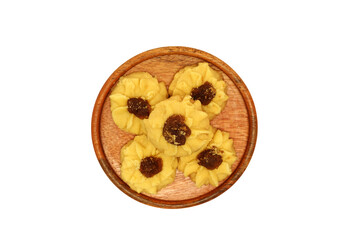 Kue semprit or Butter Cookies is a Traditional Indonesian Cookies, pineapple jam on top for Ied Al Fitr served on Wooden plate and isolated on white background 