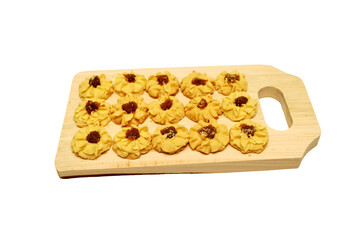Kue semprit or Butter Cookies is a Traditional Indonesian Cookies, pineapple jam on top for Ied Al Fitr served on Wooden cutting board  and isolated on white background 