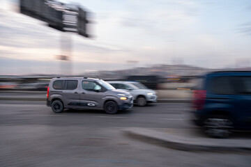 Blurred Motion of a Car on City Streets at Night: Dynamic Urban Scene with Vibrant Lights, Speed, and Nostalgic Automobile Charm