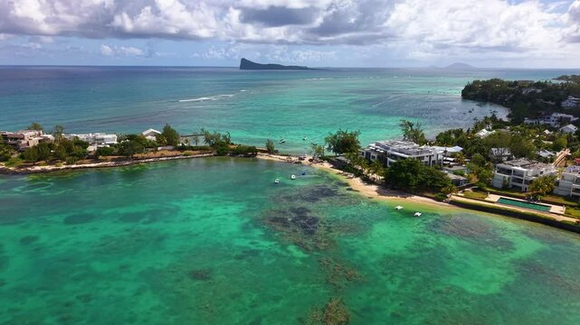Magnificent Coastal Haven With Contemporary Villas Bordered By Gradient Emerald Waters And Cloudy Horizon