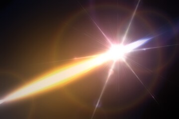 Diagonal light beam illuminating dark background with lens flare