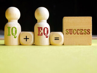 IQ + EQ = success, text on wooden toy block with copy space background. Stock photo.