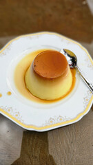 Homemade caramel custard pudding in an upside down glass on a plate, how to unmold caramel pudding.