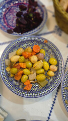 Pickled gherkins, onion, chilli and various types of olives in a bowl