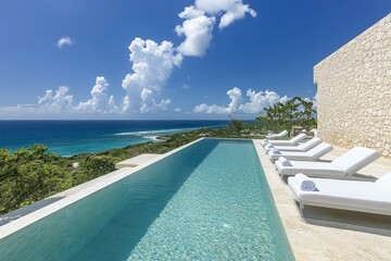 Fototapeta premium Luxurious infinity pool overlooking ocean and scenic horizon on sunny day