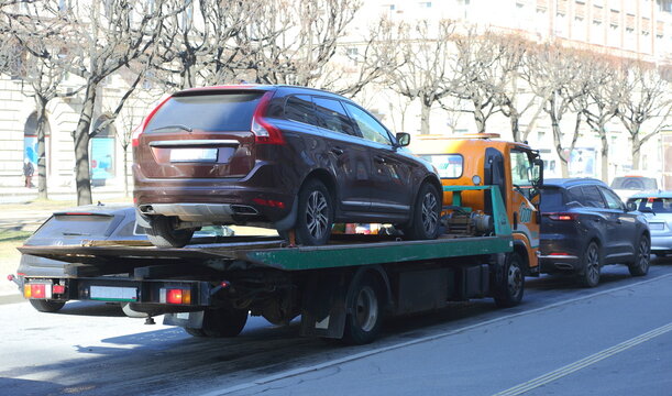 Tow truck pick up car parked in the wrong place, Novocherkassky Prospekt, Saint Petersburg, Russia, April 04, 2025